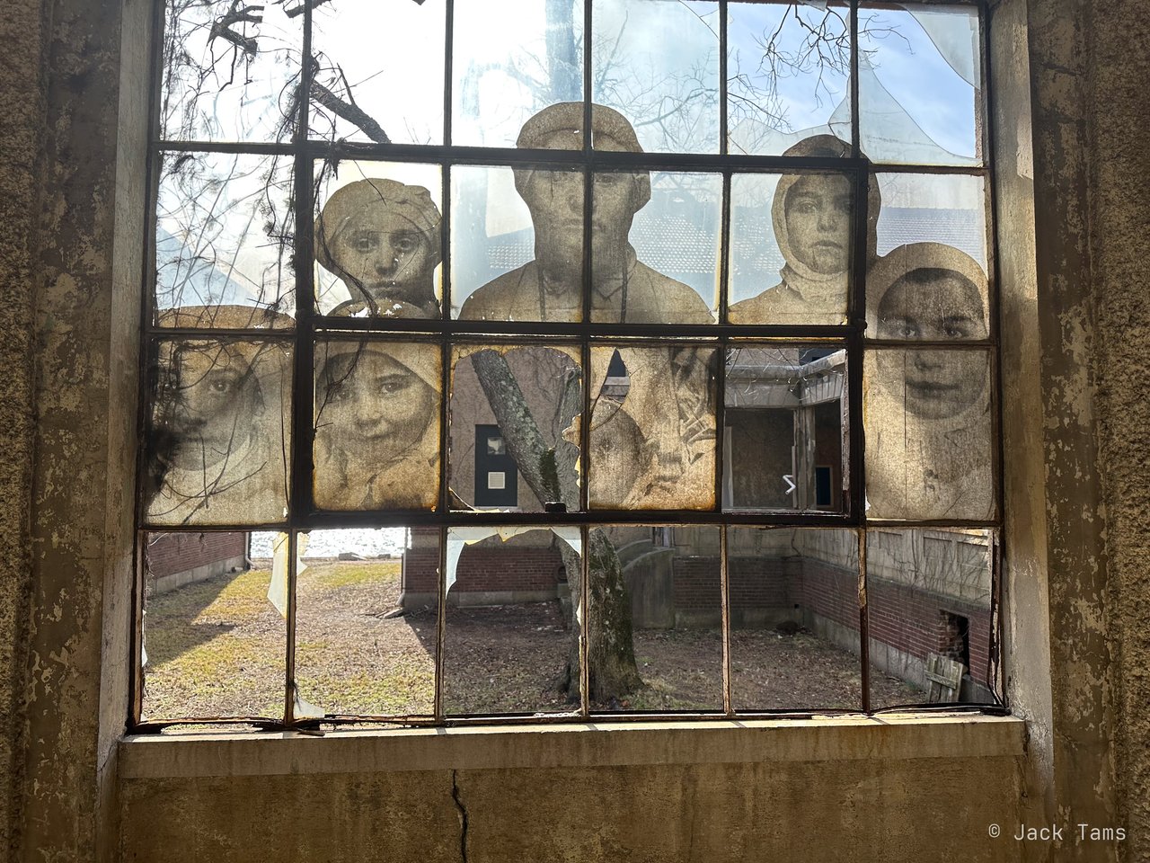 One of JR's 'Unframed' faces of immigrants, pasted across a hospital window.