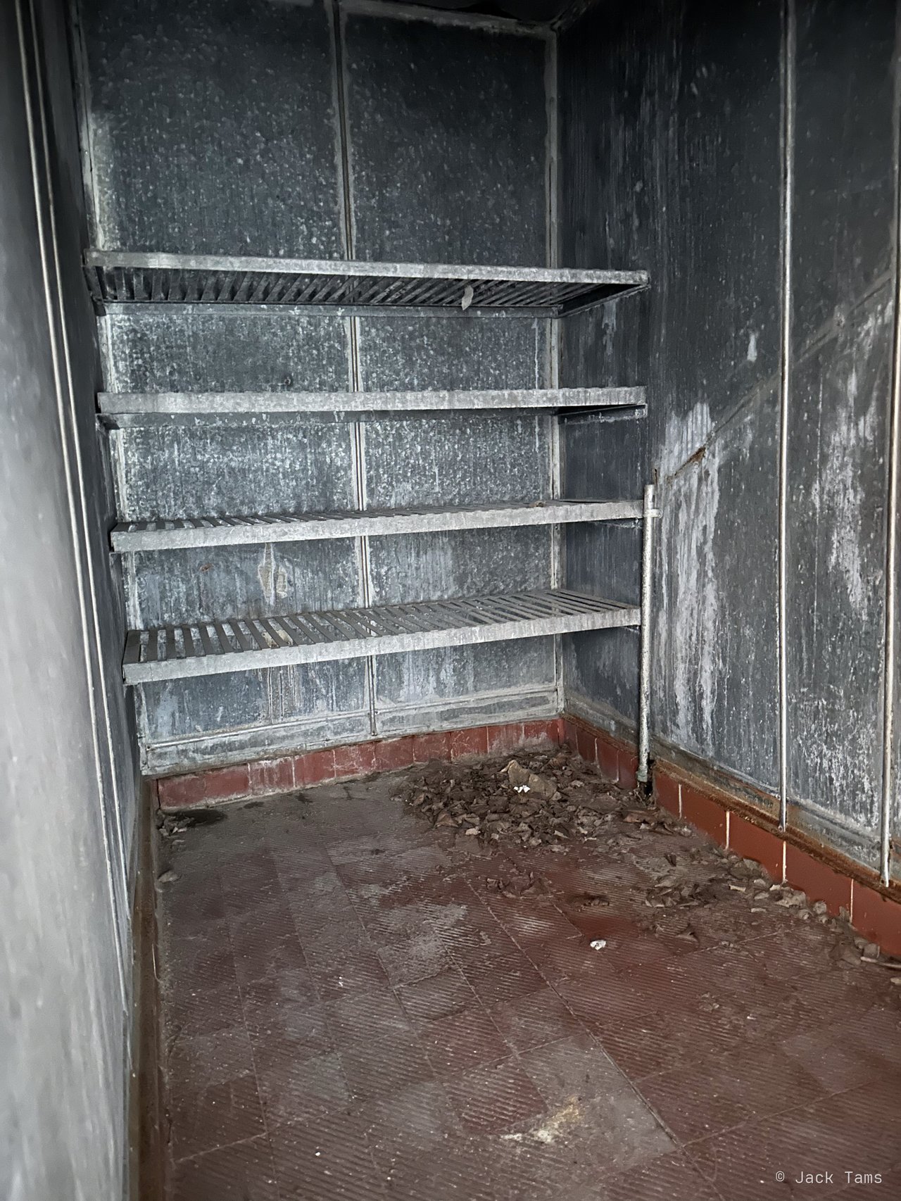 Bare shelving in a storeroom.