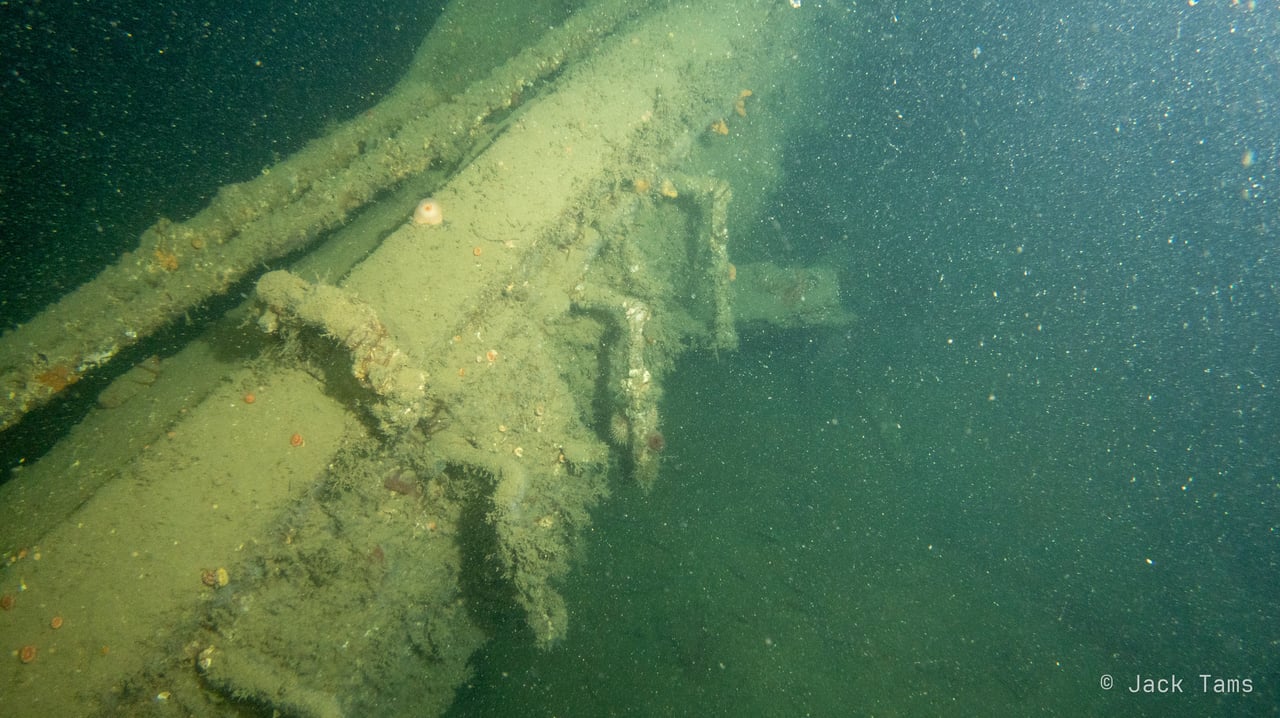 A gun barrel lying along the wreck.