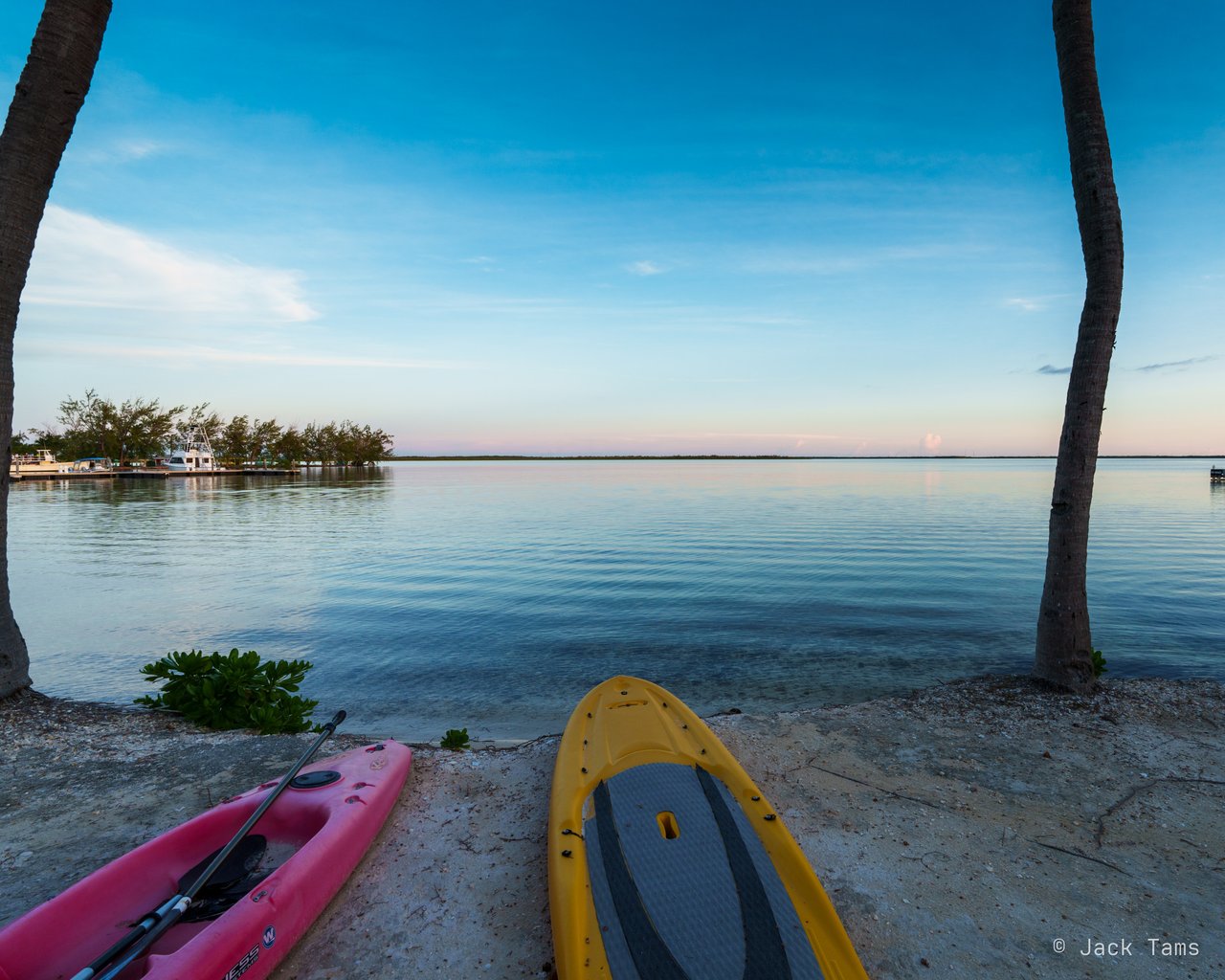 Kayaks pulled up on the shore in the evening light.