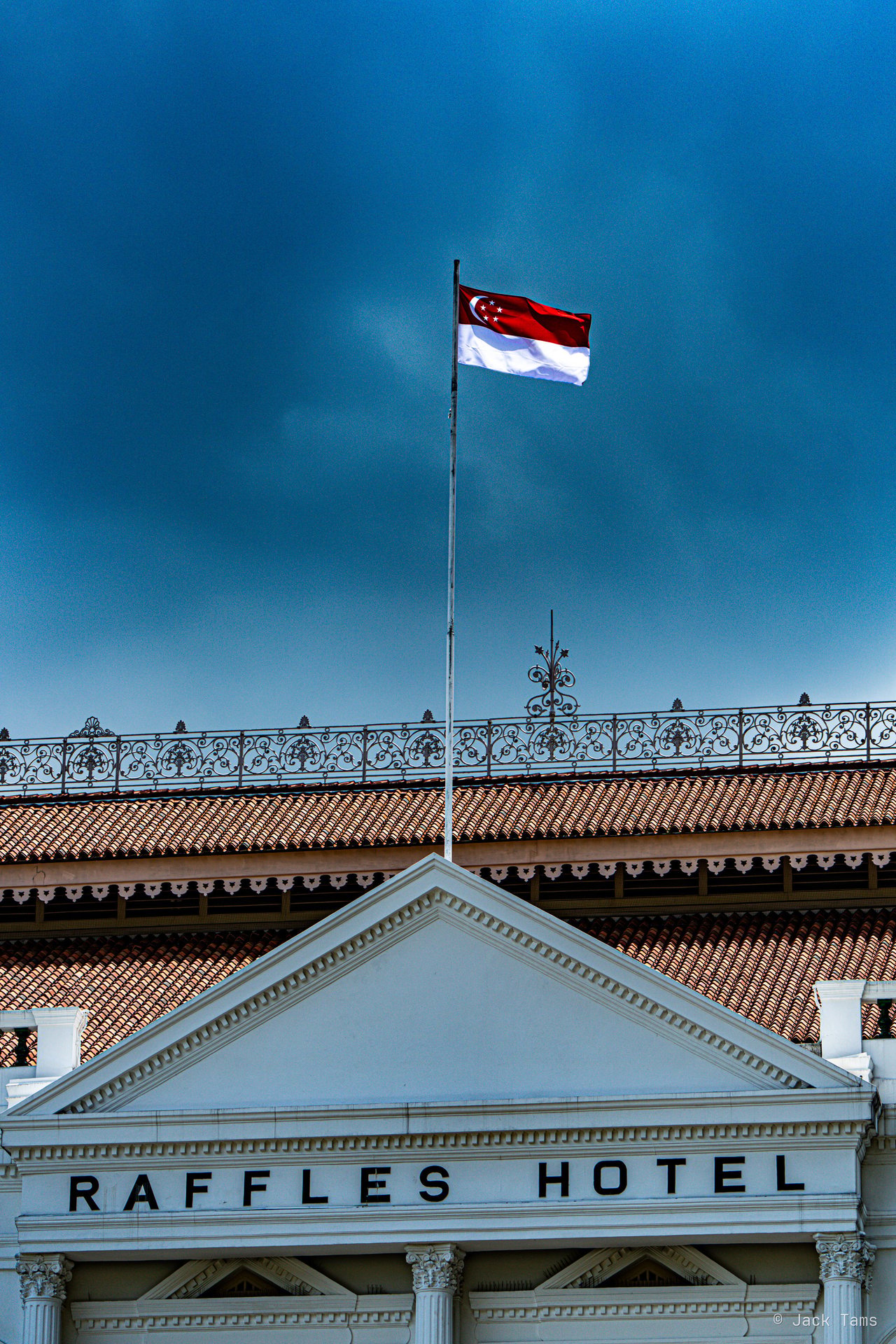 The Raffles Hotel's white façade and flag.