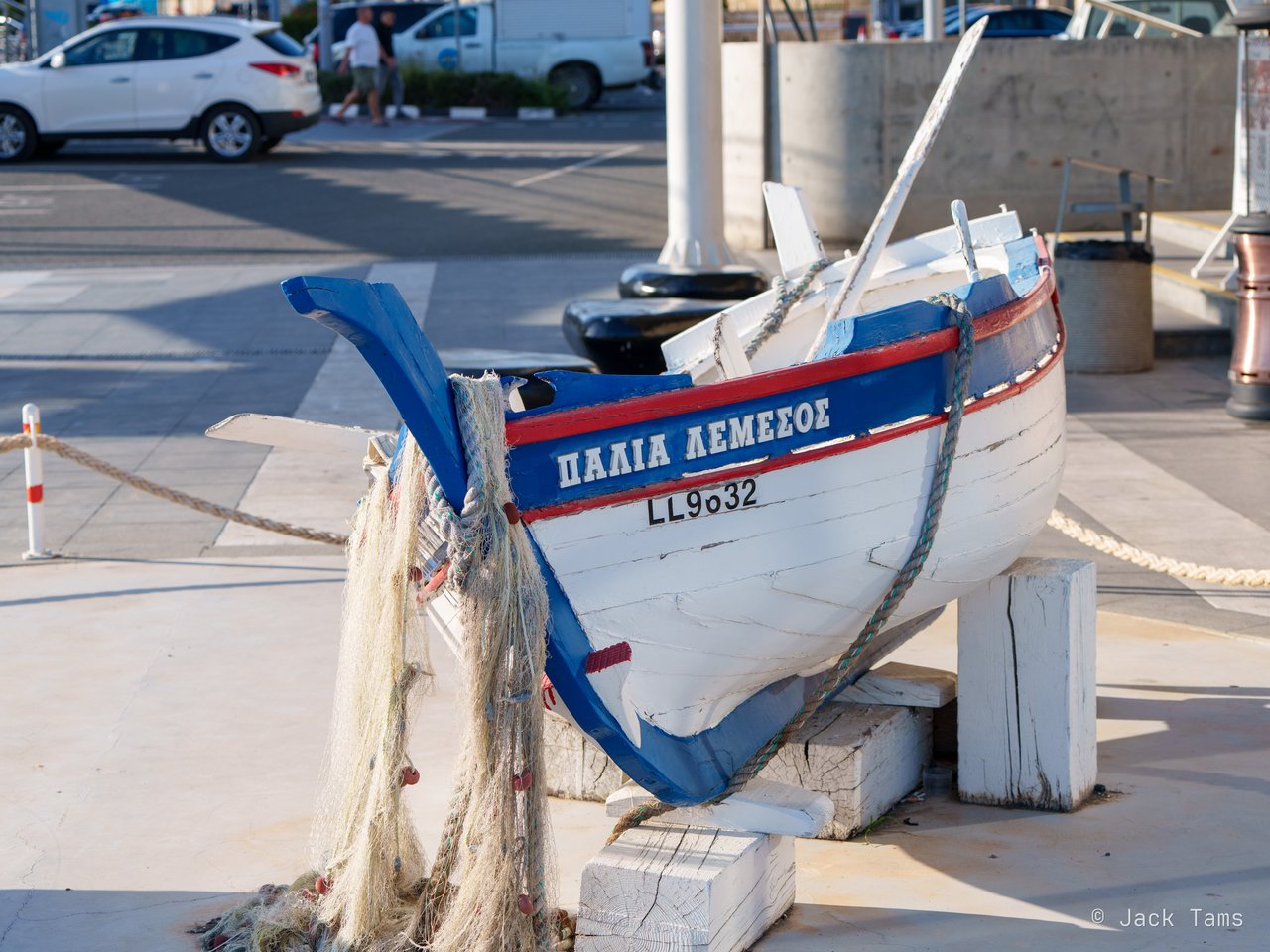 A traditional fishing boat on display by the harbour.