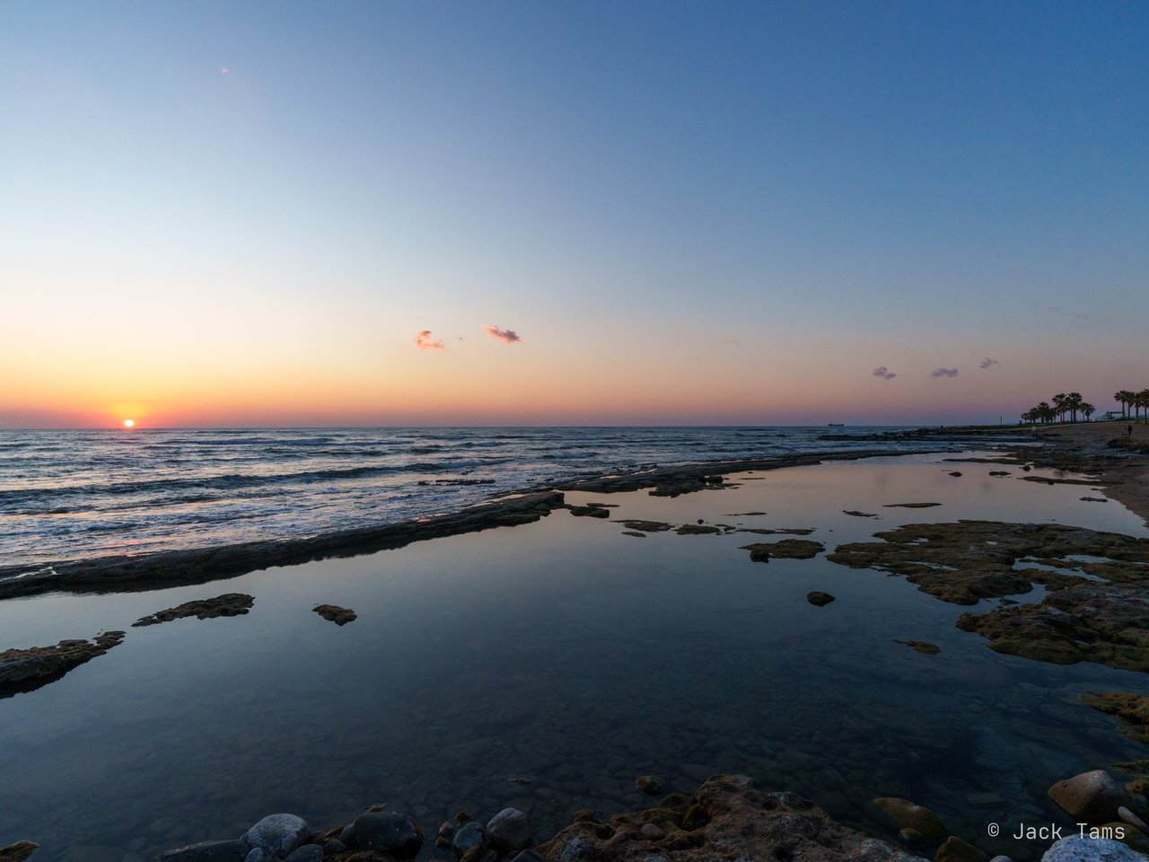 The rocky shore and rock pools after sunset.