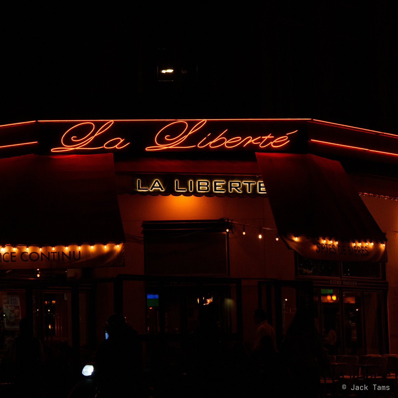 Neon on a corner café at night.