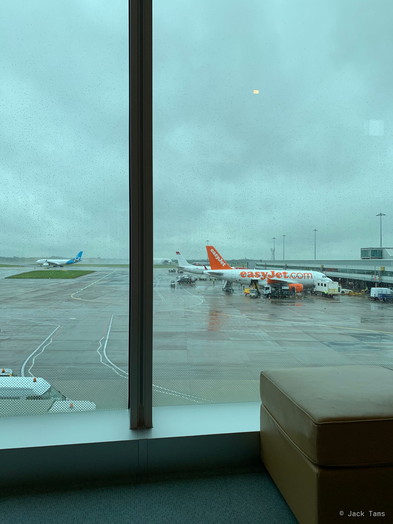 Rain on the lounge glass, looking out over the apron.