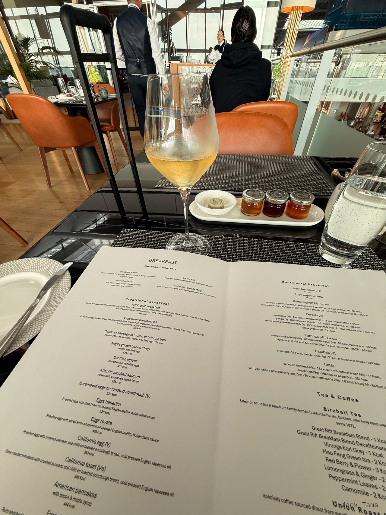 A glass of wine and the lounge menu.