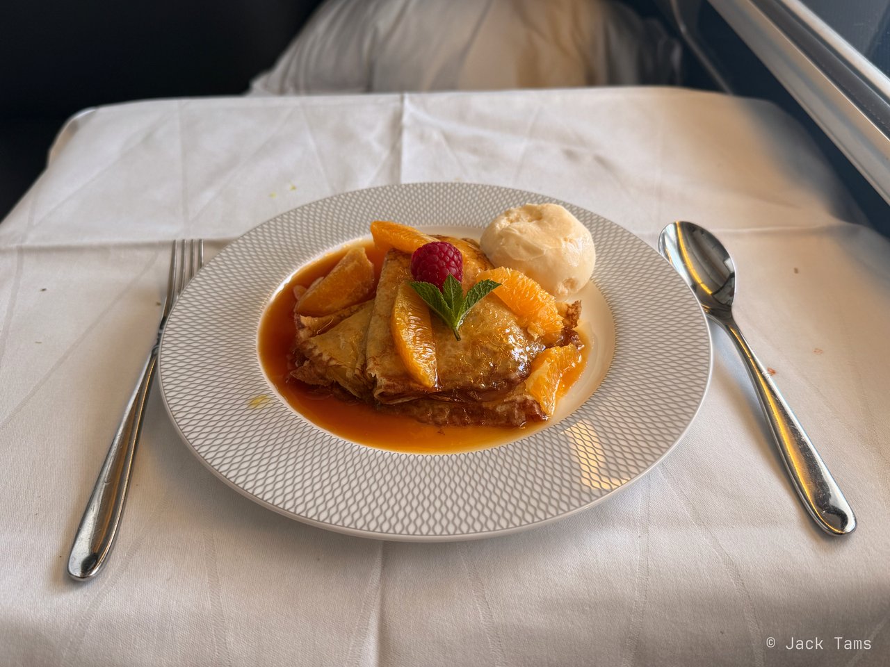 Warm crêpes Suzette with vanilla ice cream.