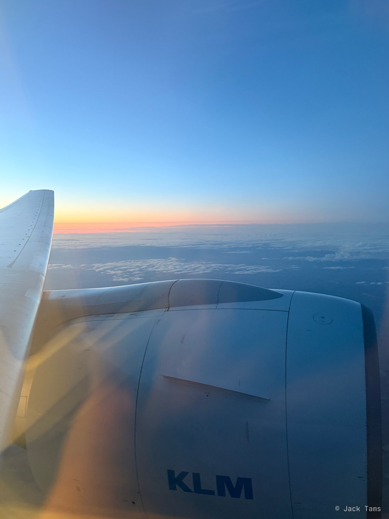 The sky glowing orange over the wing after take-off.