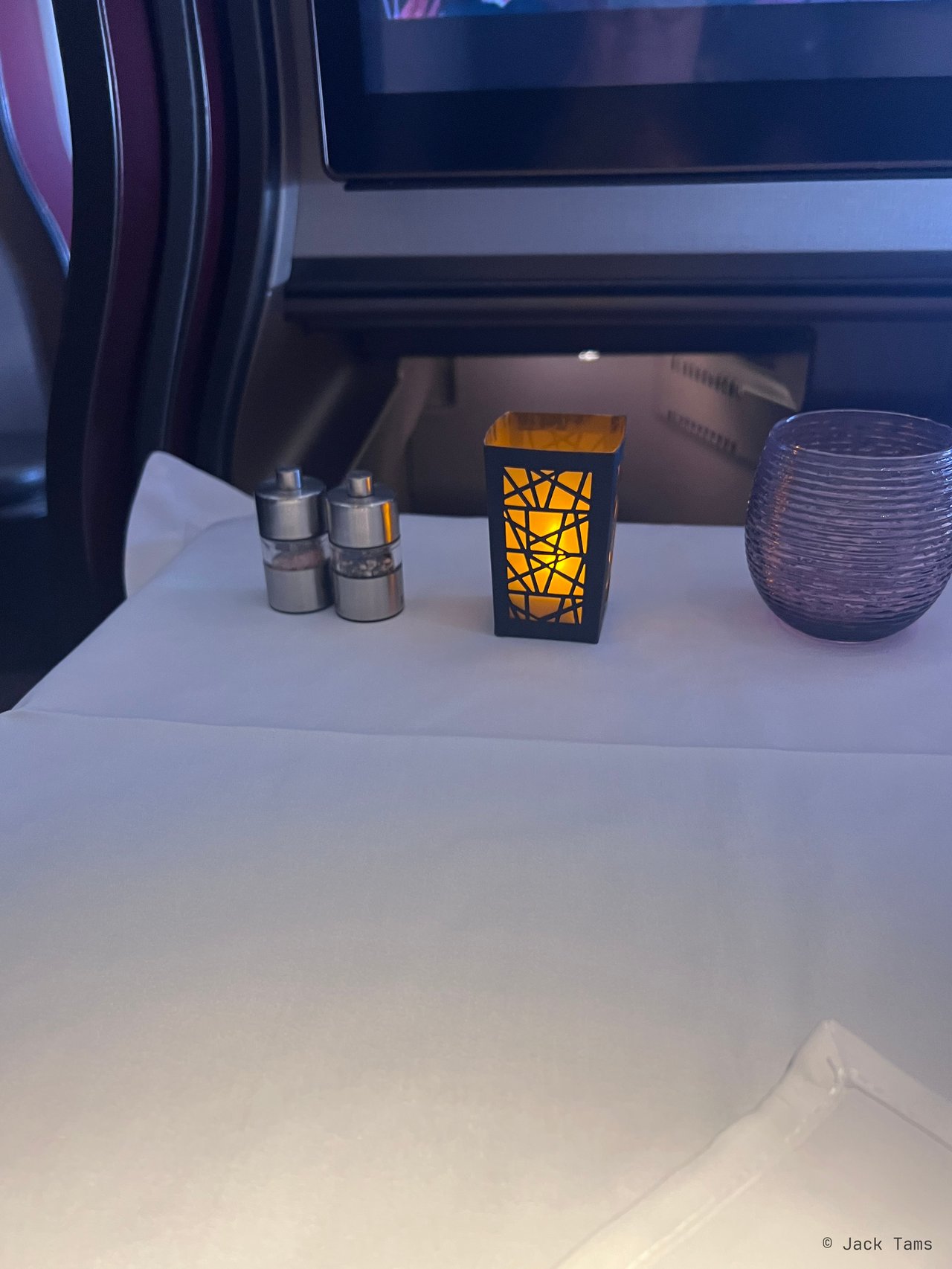 The table laid for dinner: bread, butter, oils and a candle.