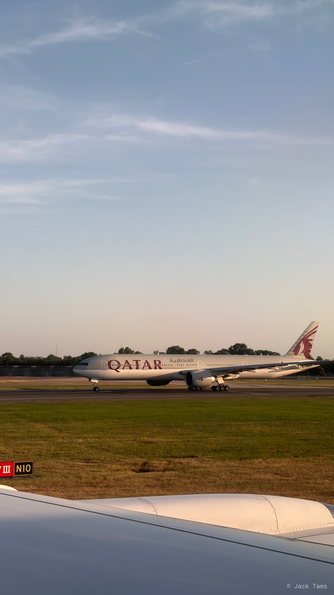A Qatar Airways jet on the taxiway.