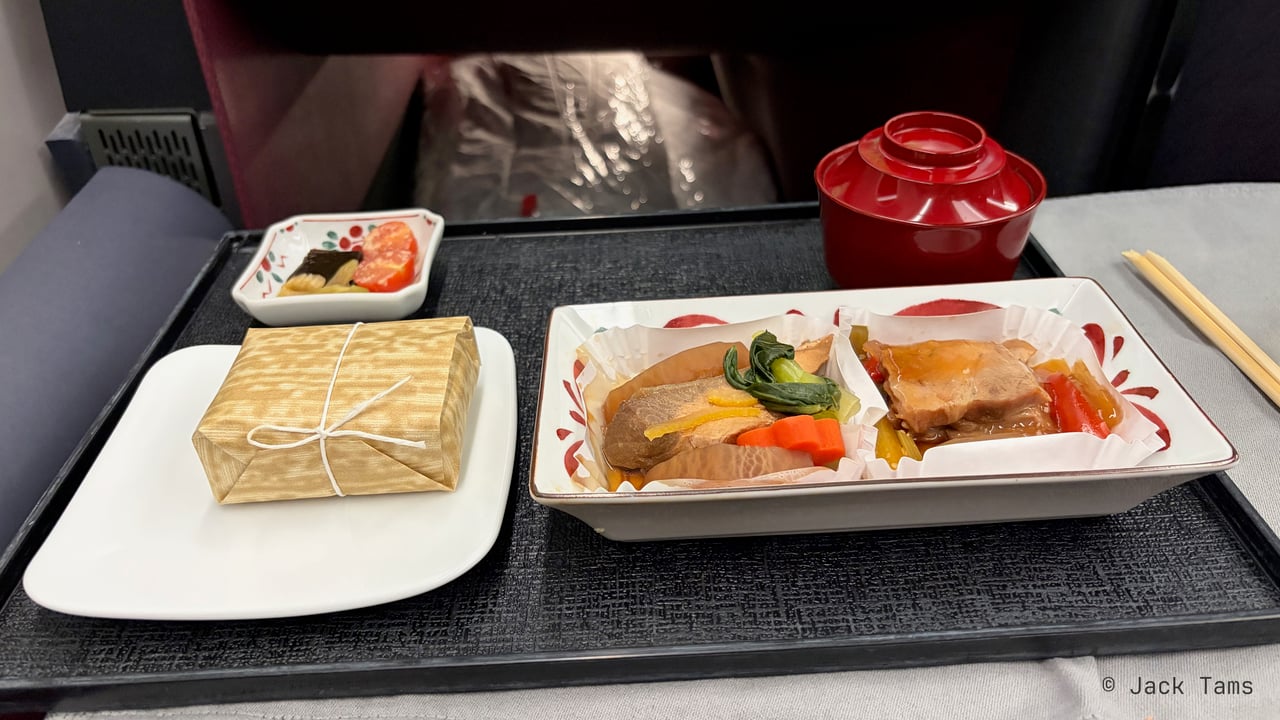 Simmered yellowtail and radish with pak choi, carrot and yuzu peel, and roast pork with marinated vegetables; steamed rice, miso soup and Japanese pickles.