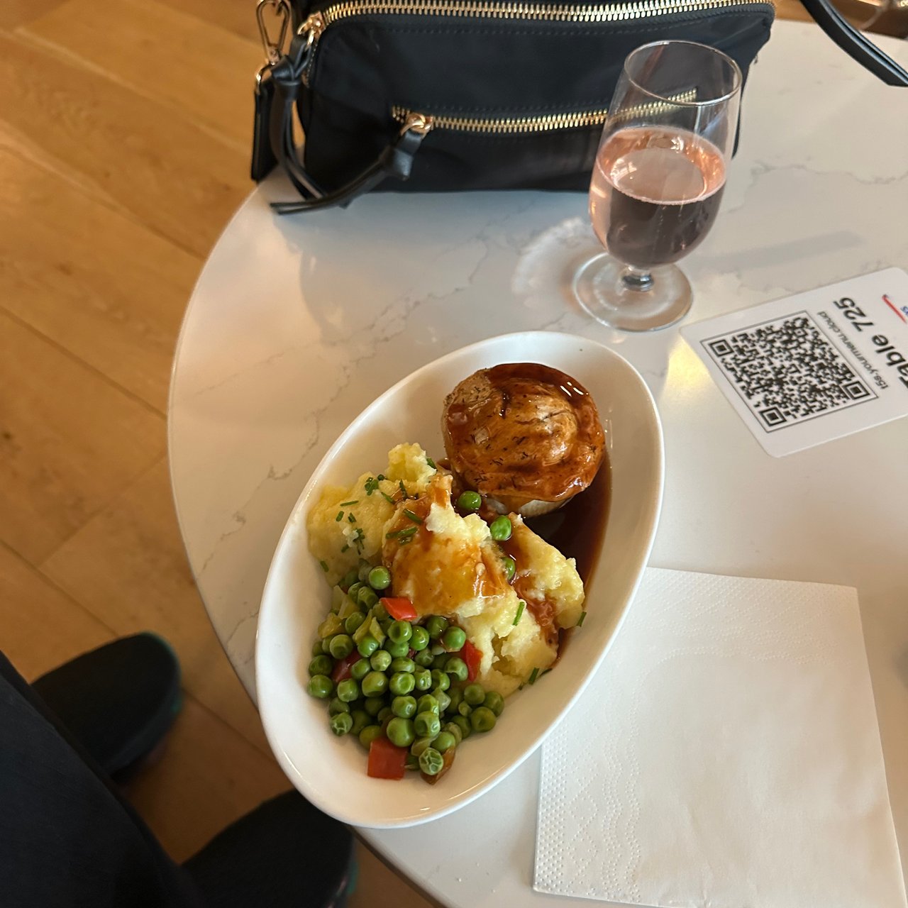 A pie with mash and peas, and a glass of rosé, in the lounge.