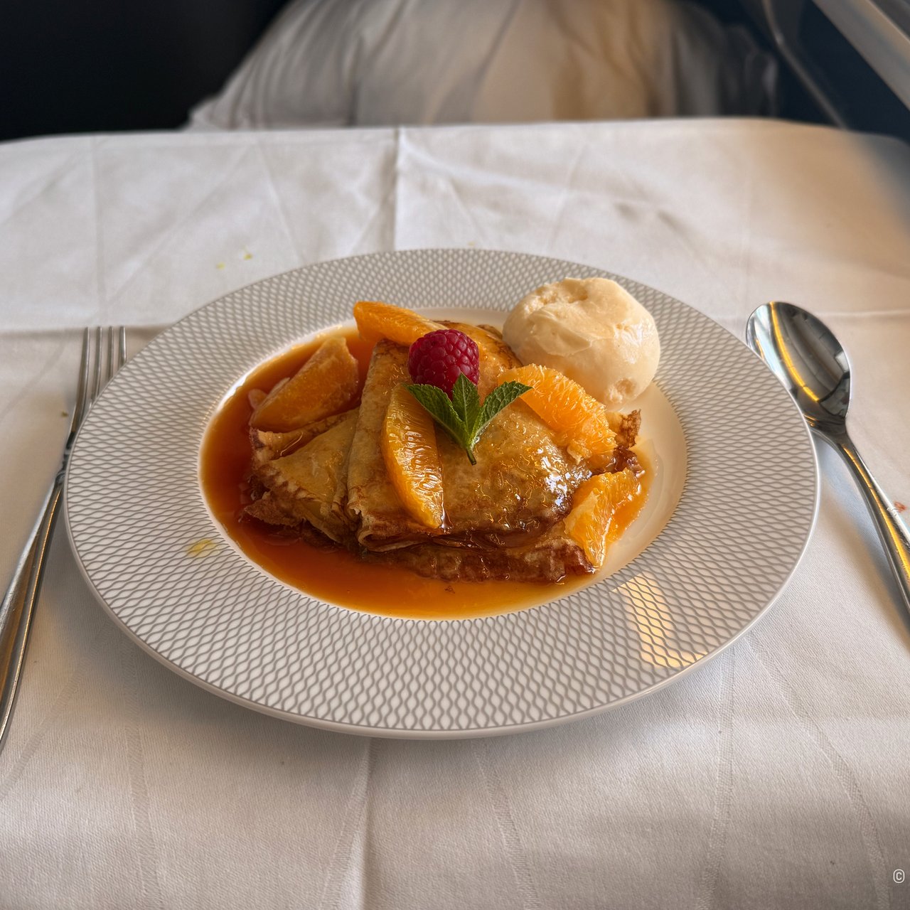 Warm crêpes Suzette with vanilla ice cream.
