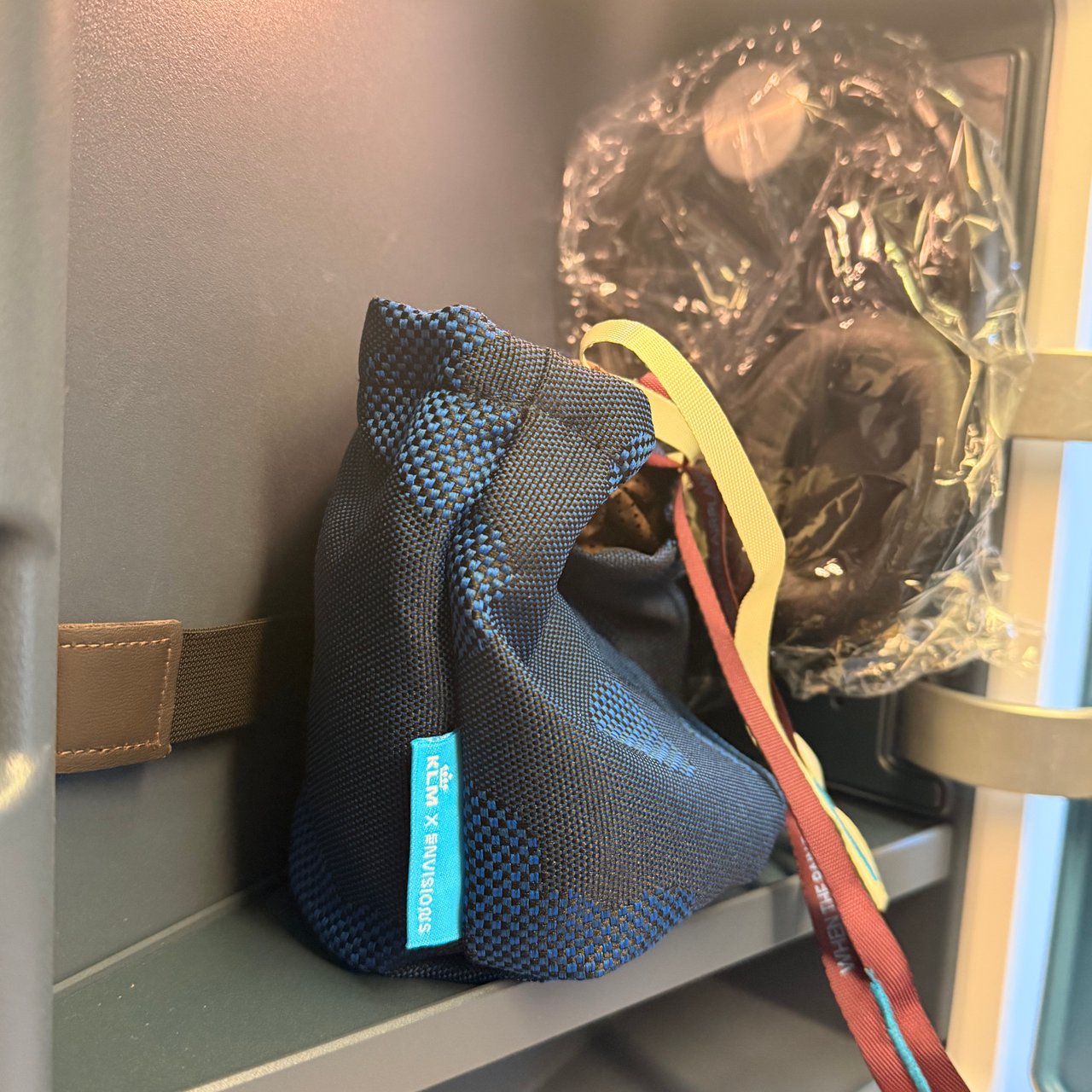 The amenity kit and headphones in the side cubby.