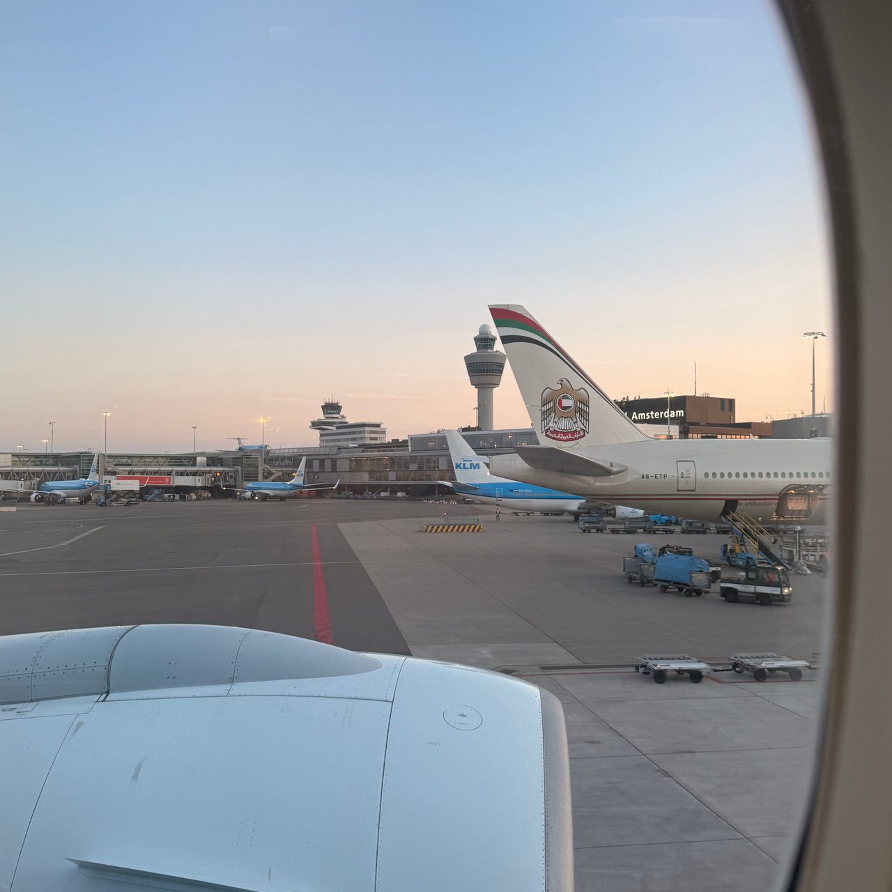 An Etihad 787 at the next stand, and the Schiphol tower.