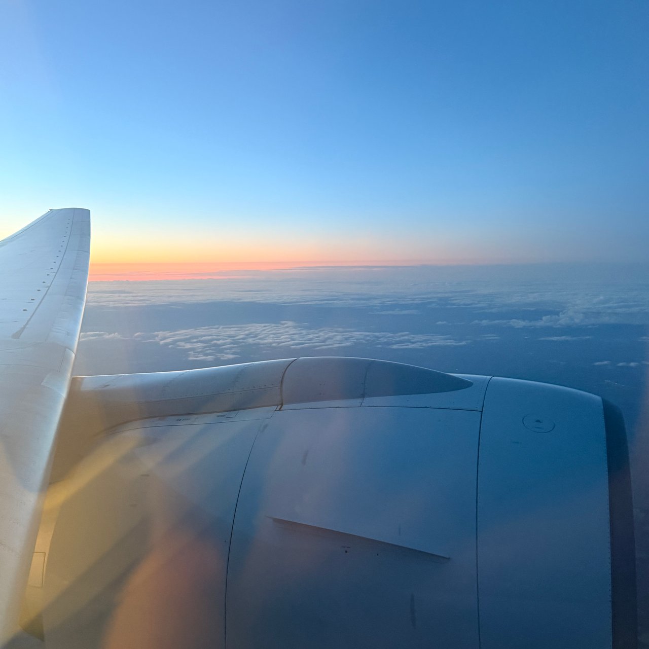 The sky glowing orange over the wing after take-off.