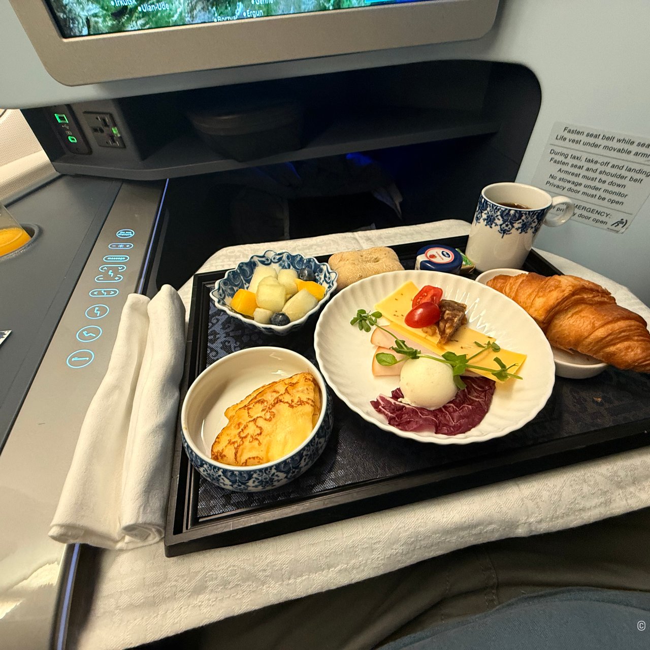 Fruit salad, the cold plate, a pancake with quark and apricot, and a croissant.