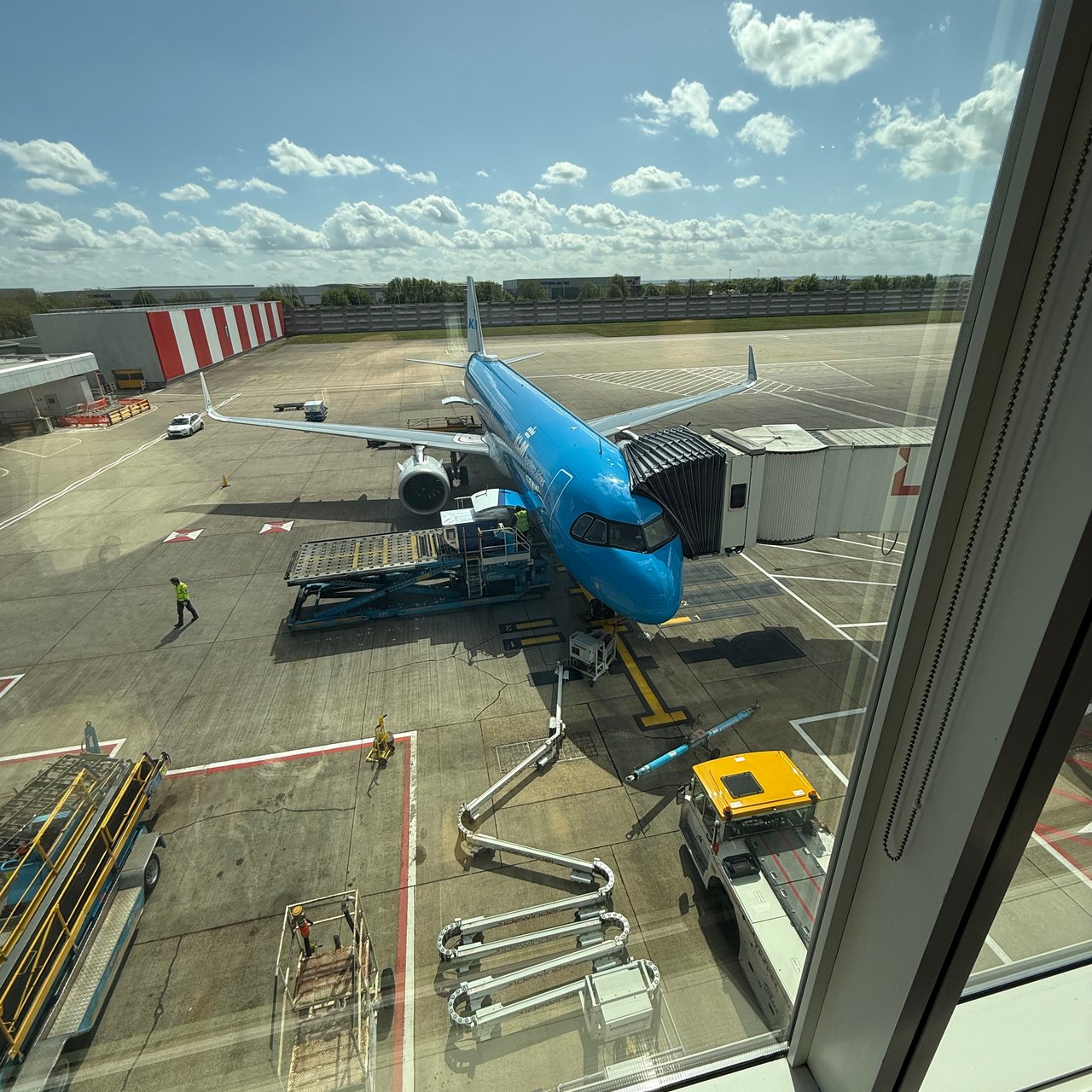 A KLM Airbus A320 at the next gate, from the lounge window.