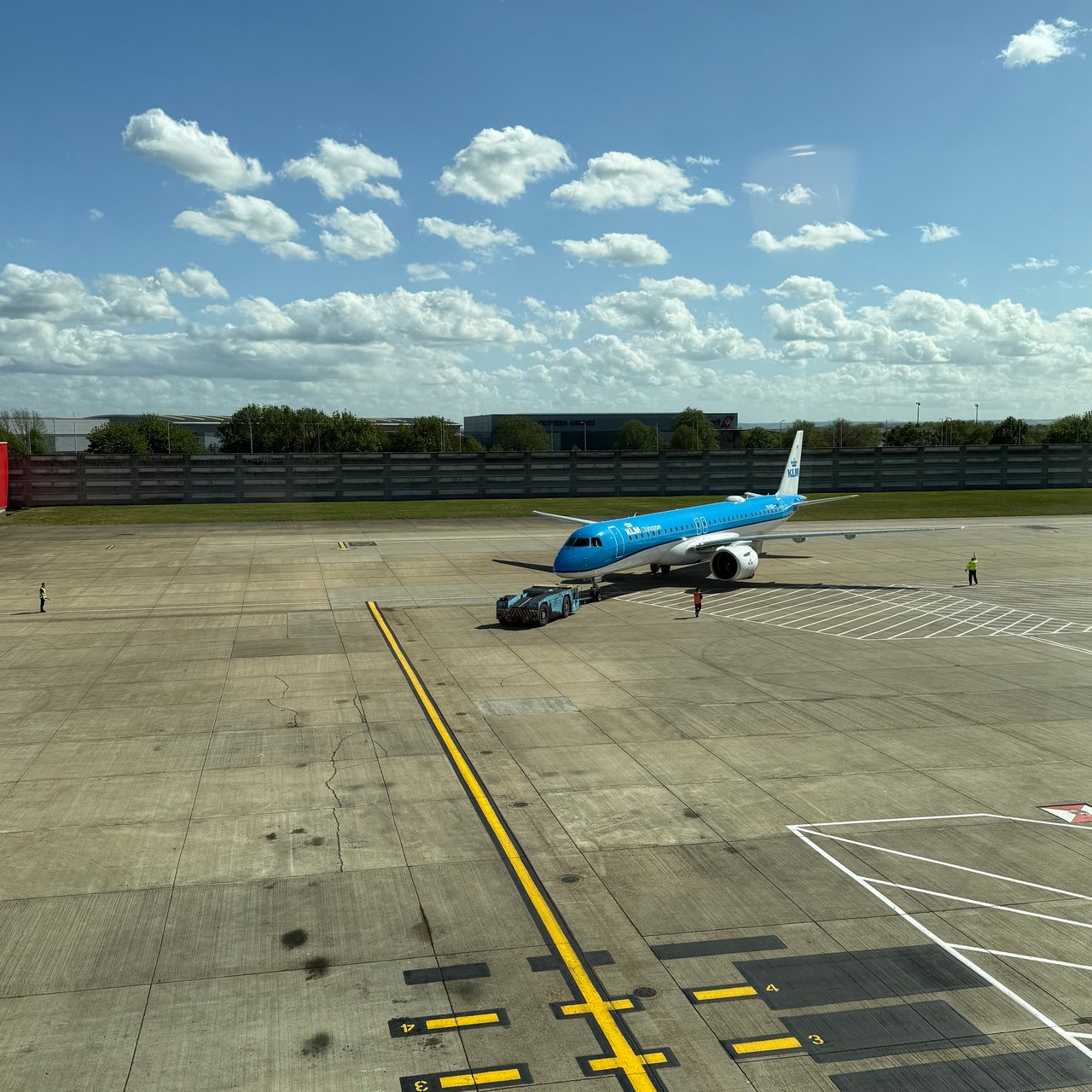 The KLM E195-E2 pushing back past the lounge.