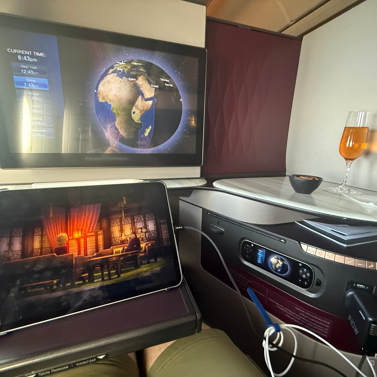 The moving map on the big screen and the iPad streaming beside it: my first flight with Starlink.