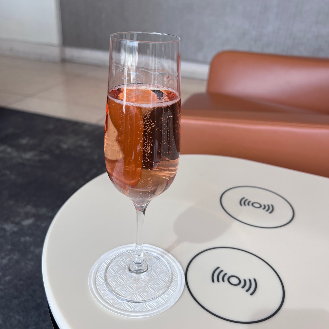 Rosé Champagne on a lounge table, the wireless chargers built in.