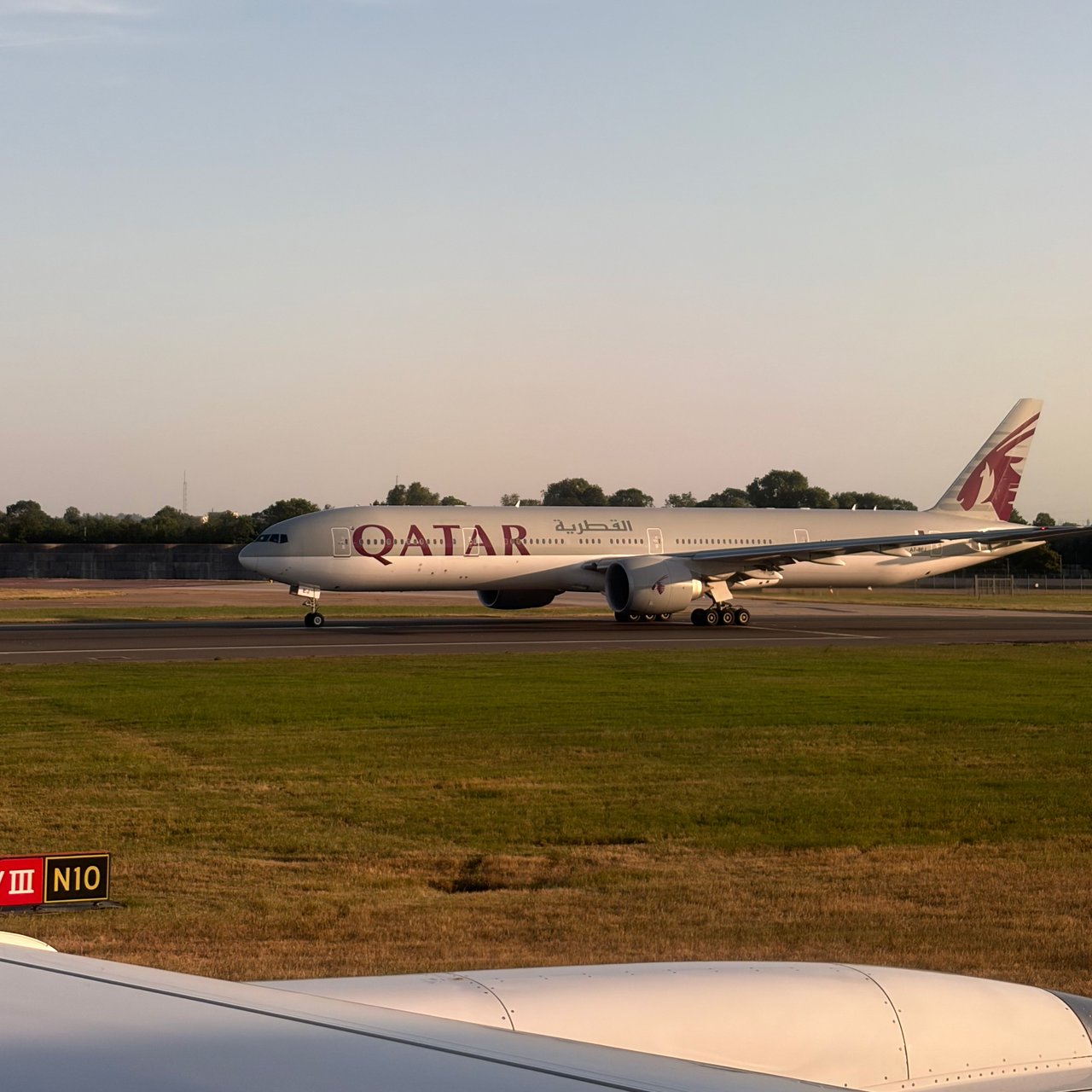 A Qatar Airways jet on the taxiway.